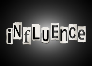 Illustration depicting a set of cut out printed letters arranged to form the word influence.
